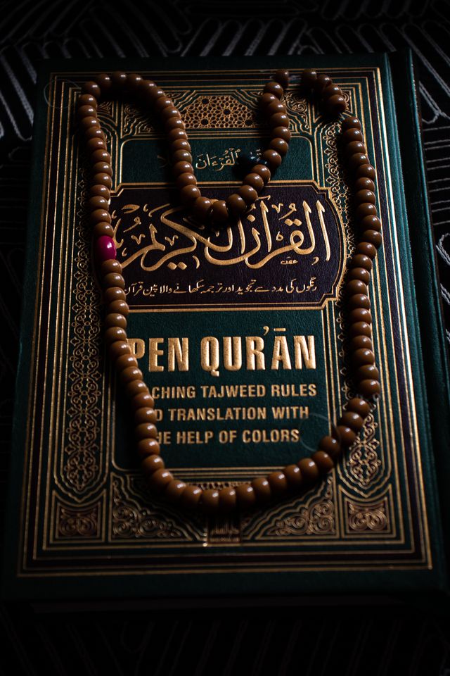 Intricate design of a Quran with prayer beads, symbolizing Islamic faith and spirituality.